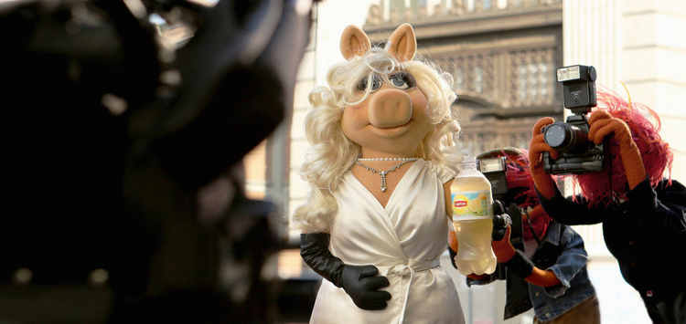 Miss Piggy―diva, fashion icon and star of Disney’s “Muppets Most Wanted”―is photographed by paparazzi (aka Animal) during the filming of Lipton’s “Be More Tea” ad, debuting during the Academy Awards, March 2, 2014.