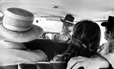 John Wayne in car with Howard Hawks, Michele Carey, and James Caan on the set of El Dorado