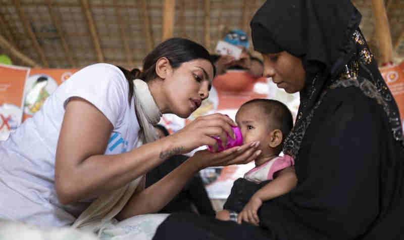 UNICEF Goodwill Ambassador Priyanka Chopra helps feed a Rohingya refugee baby at a UNICEF-supported therapeutic feeding center for malnourished children.in Jamtoli camp, Cox's Bazar district, Bangladesh on 23 May 2018. Photo: UNICEF