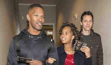 Jamie Foxx escorts Quvenzhané Wallis and Annie director Will Gluck on board an American Airlines flight to give passengers a Priceless Surprise from MasterCard