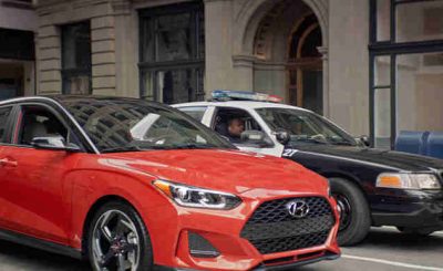 In the Hyundai ad, “Stoplight Standoff,” two police officers and a Veloster driver exchange in a very awkward standoff.