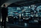 Labeled cinematic conceptual art of a futuristic MI6 command center displaying digital code structures, representing the rumored Artificial Intelligence plot of the upcoming James Bond movie.